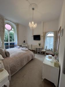 a bedroom with a bed and a living room at The Chapel Guest House in St Austell