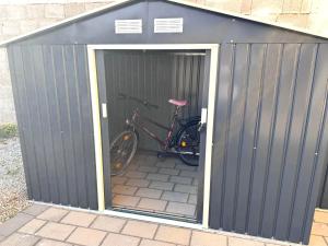 a bike is parked inside of a garage at Secret Lakeside in Frauenkirchen