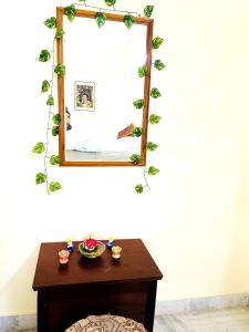 a table with a mirror on a wall with a table with a mirror at sai bliss in Puttaparthi