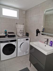 a kitchen with a washing machine and a sink at Charming apartment near La Défense, Paris in Bezons