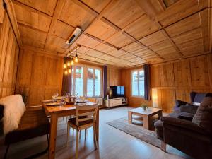 a living room with a table and a couch at Mountain Holiday in Wimmis