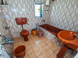 a bathroom with a tub and a toilet and a sink at Jaat House in Bhuj +25 photos