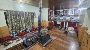 a living room with a couch and a fireplace at PASANG HOMESTAY in Leh