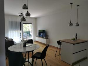 a kitchen and living room with a table and chairs at Gita Suite in Orebić