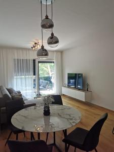 a living room with a table and a couch at Gita Suite in Orebić