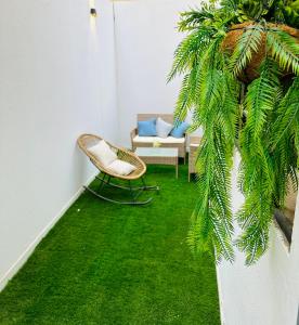a room with a chair and green grass at Riyadh Cozy Stylish One-Bedroom Apartment in Riyadh