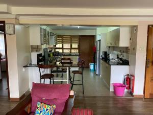 eine Küche mit einem Tisch und Stühlen im Zimmer in der Unterkunft Runda two bedroom in Nairobi
