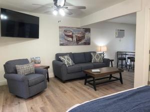 a living room with a couch and a chair at Sunset Beach Resort in Osage Beach