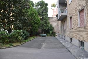 an empty street next to a building with a bench at Mocenigo4 in Milan