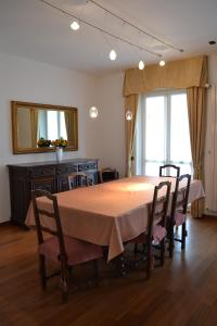 a dining room table with chairs and a mirror at Mocenigo4 in Milan