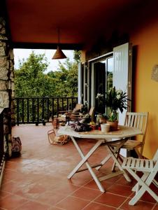 a patio with a table and chairs on a balcony at Casa da Beira Rio in Marco de Canaveses