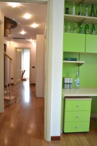 a room with green shelves and a hallway at Mocenigo4 in Milan +68 photos
