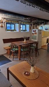 a dining room with a table and a kitchen at Penzion pod Železným Vrchem in Chřibská