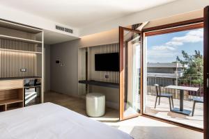 TV a/nebo společenská místnost v ubytování Hotel Netum Mare