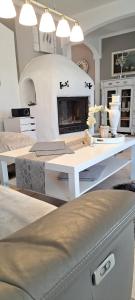a living room with a table and a fireplace at Mutti 's Landhaus in Ummern