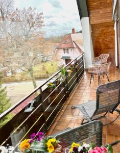 a balcony with a view of a house at Tannenduft Freudenstadt in Freudenstadt