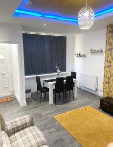 a living room with a dining room table and chairs at Comfy 2 Bedroom House Near Leeds City Centre in Leeds