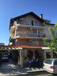 a building with a scooter parked in front of it at Guest House Gloria in Nesebar