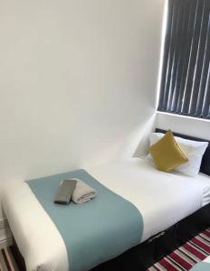 a bed with two pillows on it in a room at Comfy 2 Bedroom House Near Leeds City Centre in Leeds