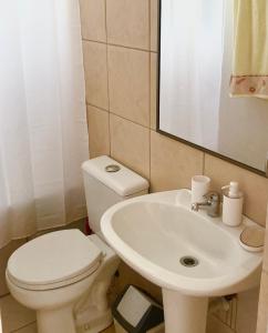 a bathroom with a toilet and a sink at Urban Lodge Providencia in Santiago