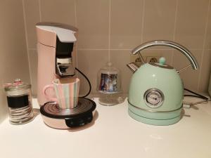 a kitchen counter with a coffee maker and a blender at Izzy's Rainbow House in De Haan