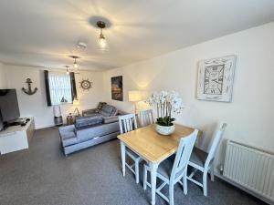 a living room with a table and a couch at Arthurs Escape in Filey