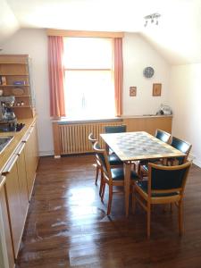 a kitchen and dining room with a table and chairs at Stranddüne in Cuxhaven