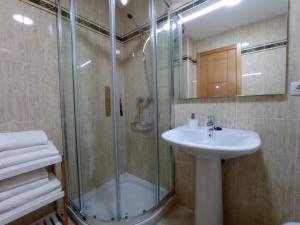 a bathroom with a glass shower and a sink at Delta in Monforte de Lemos +20 photos