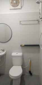 a bathroom with a white toilet and a sink at Perhentian Bay Chalet in Perhentian Island