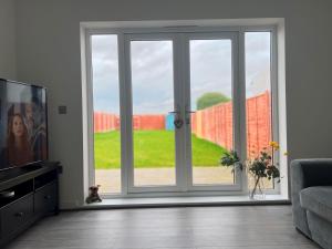 a living room with a sliding glass door at Modern 3 Bed home in Grantham in Grantham