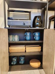 a cabinet with a printer and other items in it at 動物園前駅まで徒歩5分/通天閣近く/道頓堀エリアまで電車3分/大阪グルメ旅行に最適！ in Osaka
