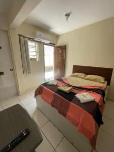 a bedroom with a bed and a table in it at Hotel Paradiso in João Pessoa