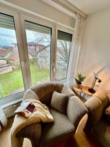 a living room with a couch and a large window at Stan na dan Kej Una in Bosanska Dubica