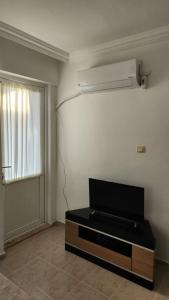 a living room with a tv on the wall at Huge Evleri 2 in Marmaris