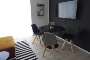 a room with a table and chairs and a television at Apartment Annett in Senftenberg +14 photos