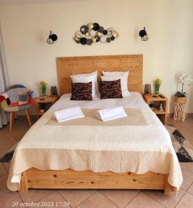 a bedroom with a wooden bed with two pillows at Belle Vue de St Gervais in Saint-Gervais-les-Bains