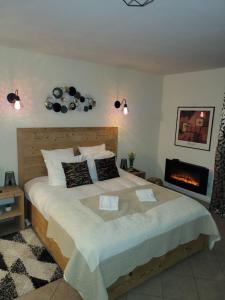 a bedroom with a large bed and a fireplace at Belle Vue de St Gervais in Saint-Gervais-les-Bains