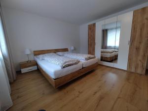 a bedroom with a bed and a large mirror at Ferienhaus Sarah in Schruns-Tschagguns