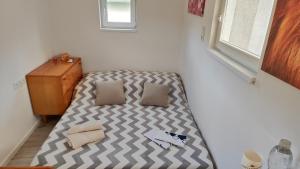 a bed with two pillows on it in a room at Apartmán tiny house v prírode 