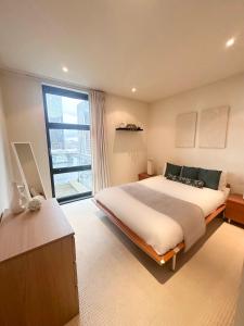 a bedroom with a large bed and a large window at Central London Large 1 Bed flat with Balcony in London