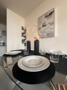a glass table with a plate on top of it at Central London Large 1 Bed flat with Balcony in London