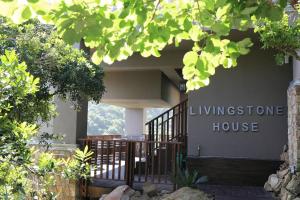 a house with a sign that reads livingstone house at Livingstone Villa in Wilderness
