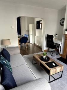 a living room with a couch and a table at 2-bedroom house in Cheltenham town centre in Cheltenham +39 photos