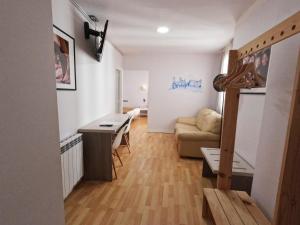 a living room with a table and a couch at Casual Gurea in Bilbao