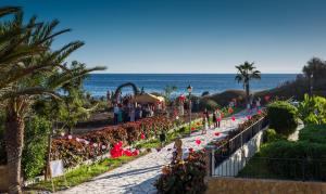 a group of people walking down a path near the beach at Apartamentos Charco del Conde in Valle Gran Rey