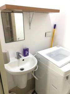 a bathroom with a white sink and a mirror at WIND RESIDENCES Tagaytay Condo STAYCATION in Silang