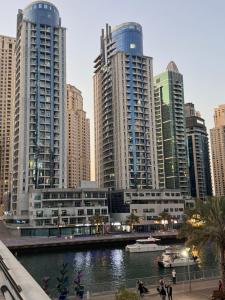 a city with tall buildings and a river at Luxury apartment 3 beds Marina view in Dubai