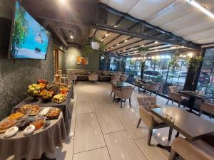 a restaurant with tables and chairs with food on them at Home Boutique Hotel in Baku