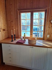 a kitchen with a counter with two candles on it at Øen cabin in Geilo by Norgesbooking in Geilo