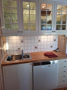 a kitchen with white cabinets and a sink at Øen cabin in Geilo by Norgesbooking in Geilo